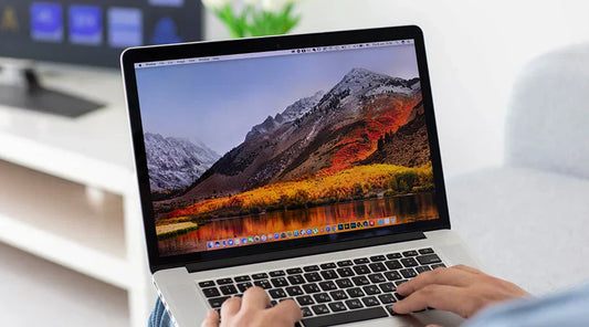 Customer checking MacBook Pro condition before purchase at PayMore Snellville